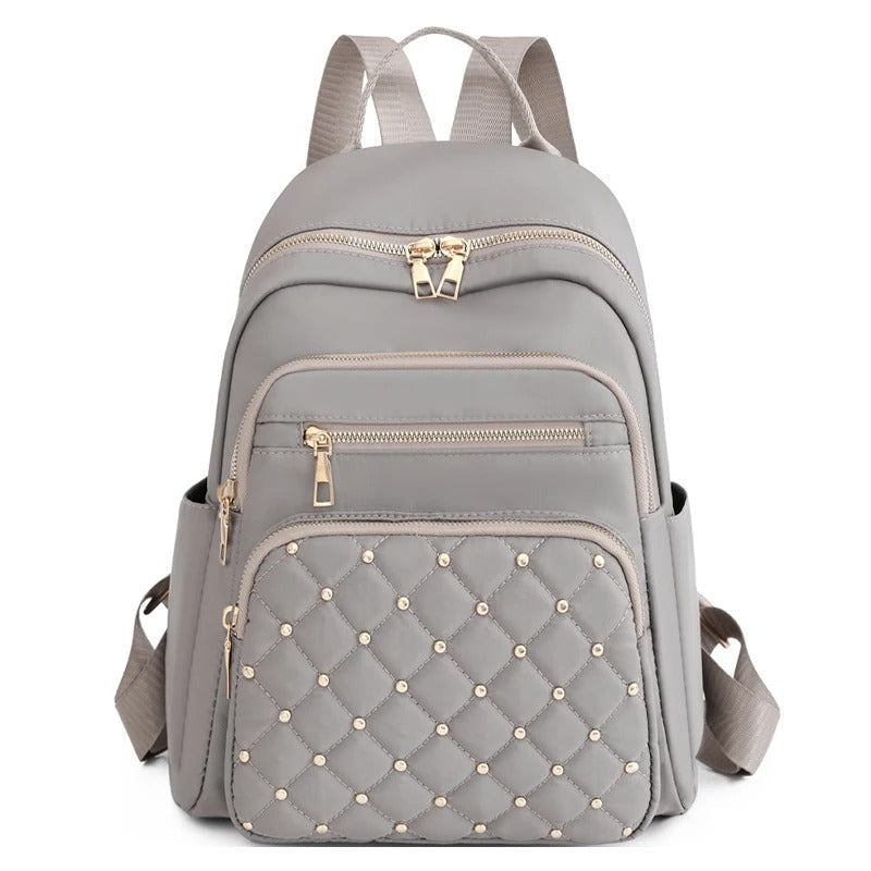 Stylish women's nylon backpack, water-resistant & lightweight for versatile travel & school use.