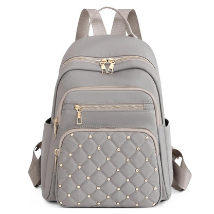 Stylish women's nylon backpack, water-resistant & lightweight for versatile travel & school use.