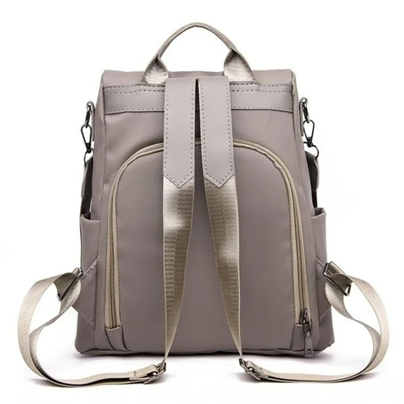 Close-up of durable, water-resistant nylon on a women's multi-way backpack. Lightweight & easy to clean travel bag.