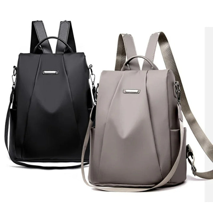 Traveler with a sleek, lightweight water-resistant nylon backpack, perfect for trips. Multi-way carry travel bag.