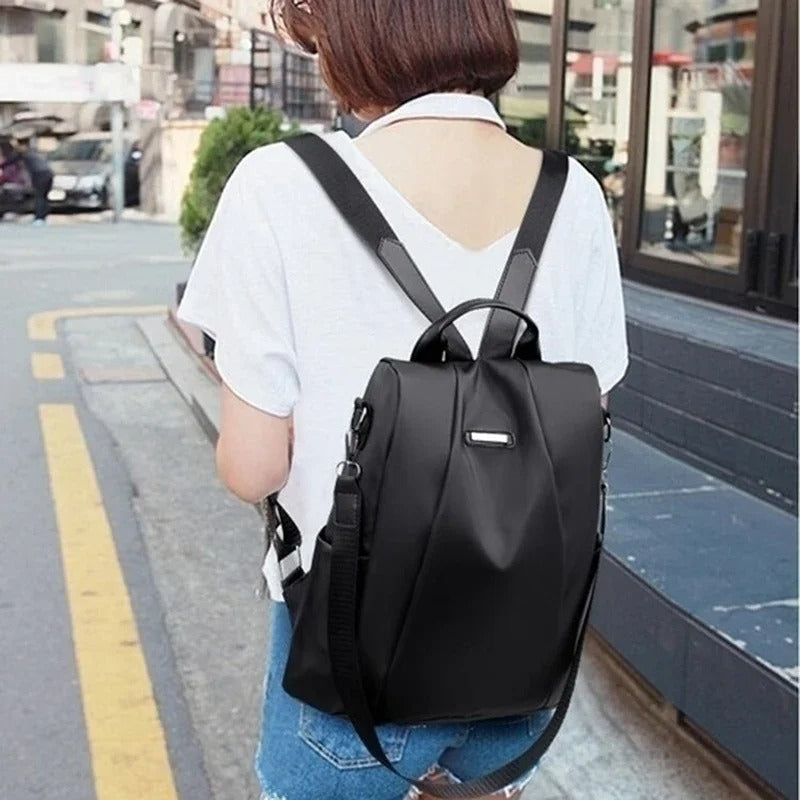 Minimalist everyday carry: lightweight water-resistant nylon women's backpack, convertible to shoulder/crossbody.
