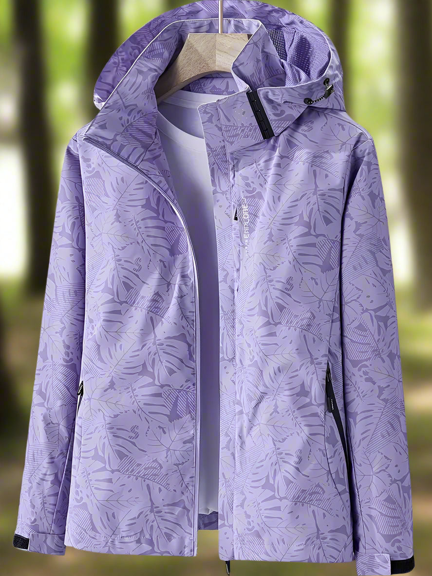 Detailed close-up of a women's lightweight waterproof jacket, showcasing its unique leaf print pattern.