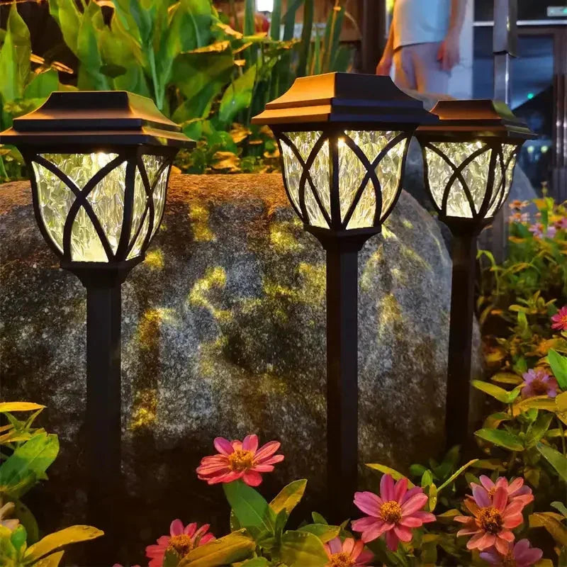 LunaGlow solar garden path lights illuminating a lush green lawn at dusk, perfect outdoor LED lighting.
