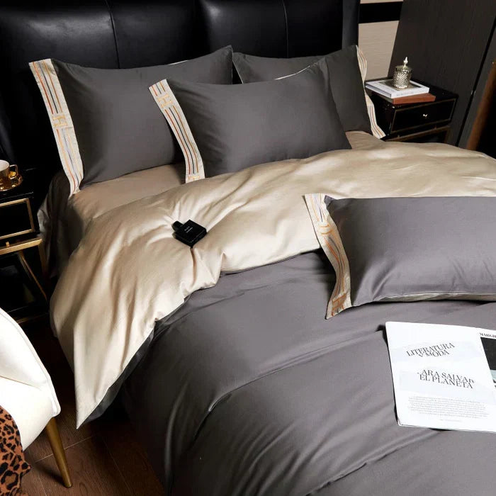 Close-up of delicate embroidery on a premium satin cotton duvet cover, highlighting luxury detail and craftsmanship.
