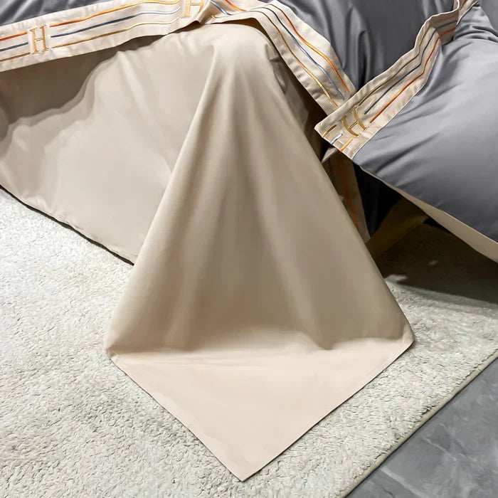 White embroidered satin cotton duvet cover drapes softly over a bed, offering premium comfort and style.