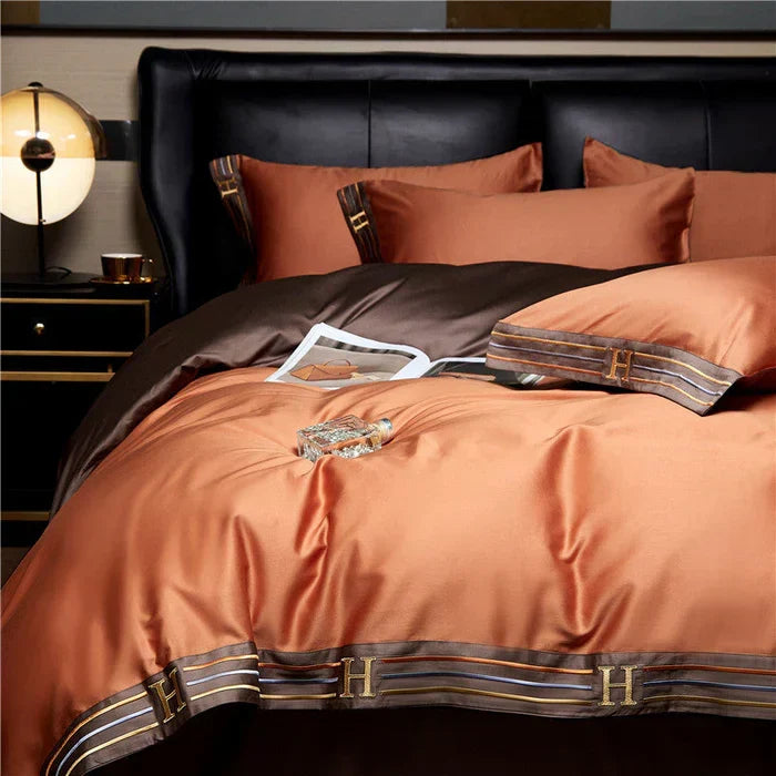 Neatly folded luxury embroidered satin cotton bedding set, showcasing premium fabric and exquisite craftsmanship.