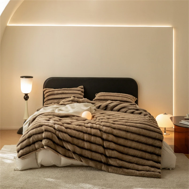 Cozy faux fur throw blanket, perfect for snuggling in living room or bedroom, adding warmth & style.