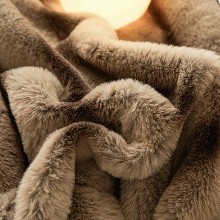 Stylish faux fur blanket, resembling rabbit fur, enhancing living room decor with its softness.