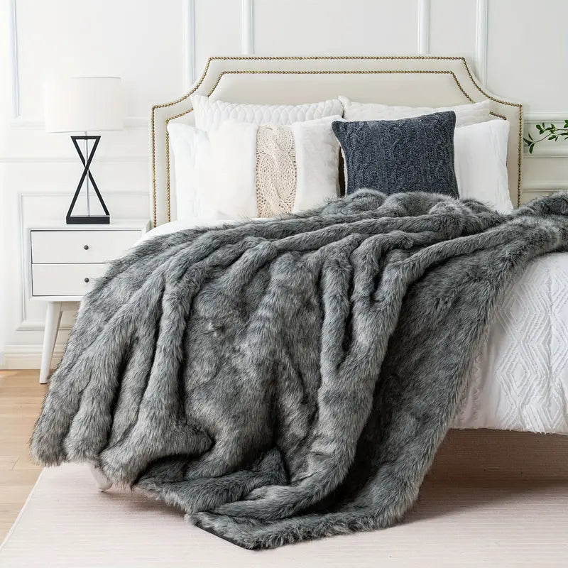 Stylish faux fur throw blanket, versatile for home decor. Provides luxurious, ultra-soft, and cozy comfort.