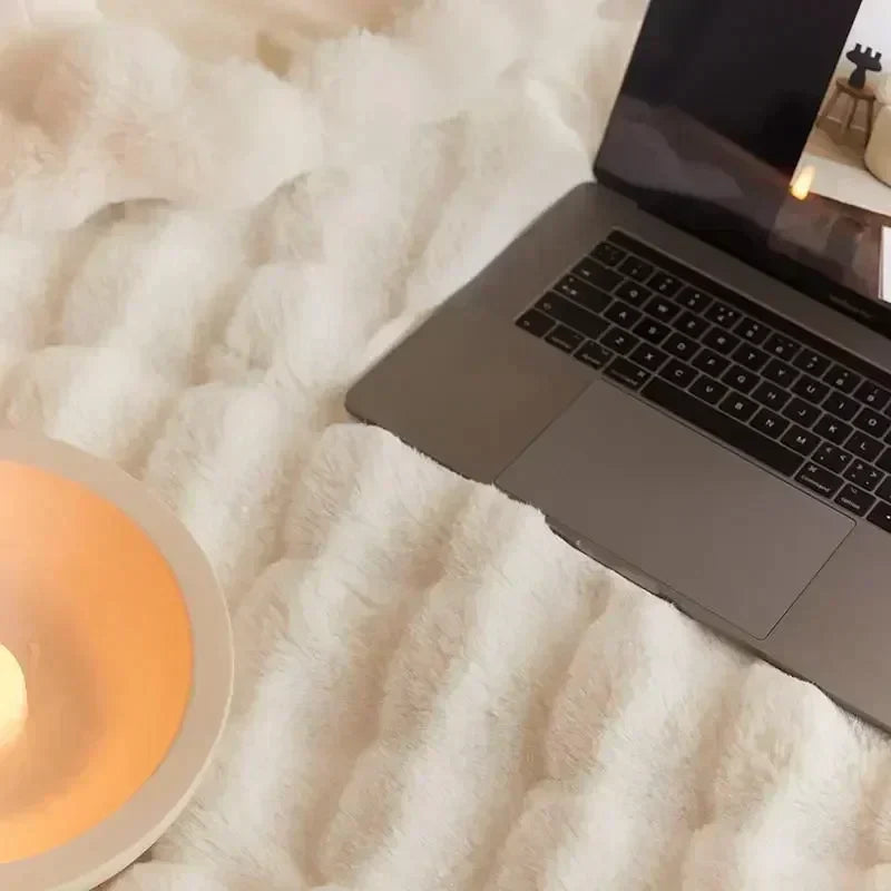 Softest faux fur blanket, portable & cozy, ideal for snuggling on bed or sofa, adds warmth.