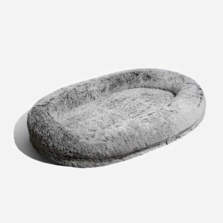 Oversized shared calming pet bed for humans & pets. Plush, machine washable faux fur provides ultimate comfort.