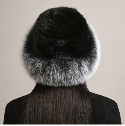 Woman models a cozy, insulated winter hat. Luxurious & warm for cold weather style. Premium fall/winter.