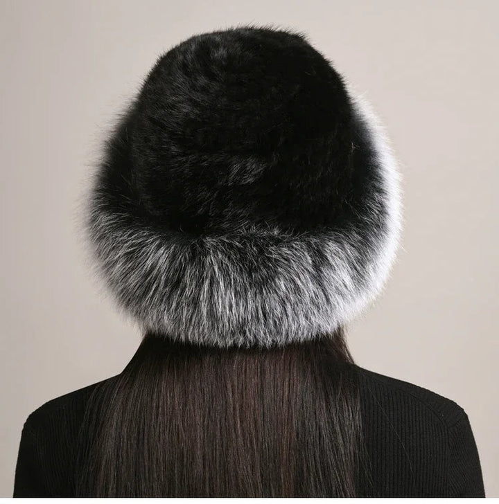Woman models a cozy, insulated winter hat. Luxurious & warm for cold weather style. Premium fall/winter.