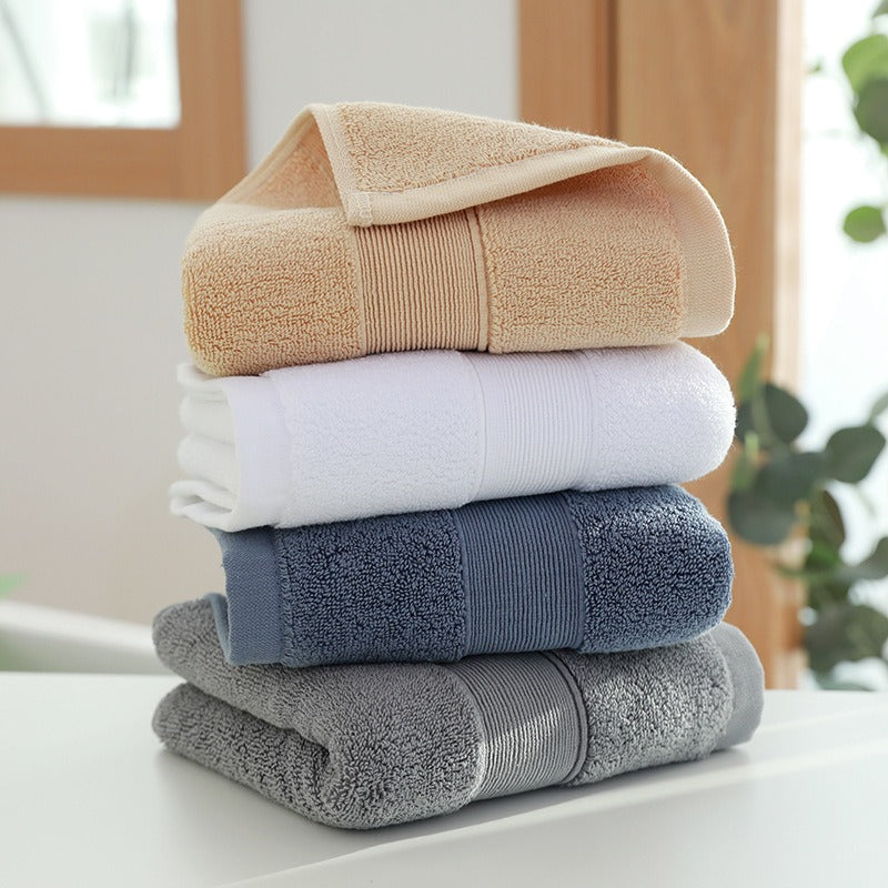 Stack of soft, luxurious cotton bath towels, perfect for bathroom essentials.