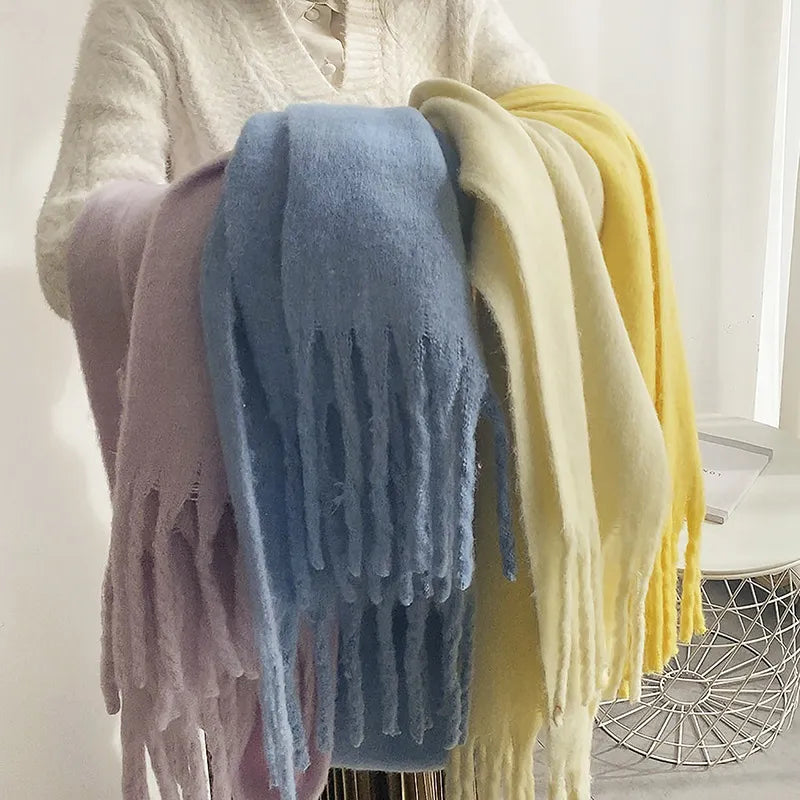 Woman wearing a warm, long cashmere scarf, styled for winter fashion.