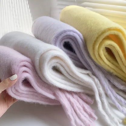 Draped luxurious women's cashmere scarf, highlighting its soft flow & winter elegance.