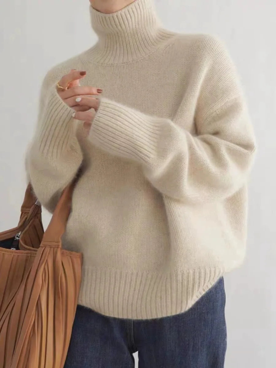 Luxurious women's relaxed fit turtleneck sweater. Oversized, elegant, and cozy for winter fashion.