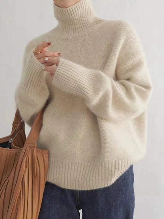 Luxurious women's relaxed fit turtleneck sweater. Oversized, elegant, and cozy for winter fashion.