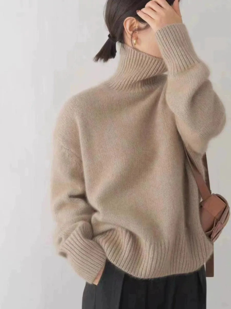 Elegant women's neutral-colored turtleneck. Luxurious, relaxed fit, long sleeve, cozy for winter fashion.