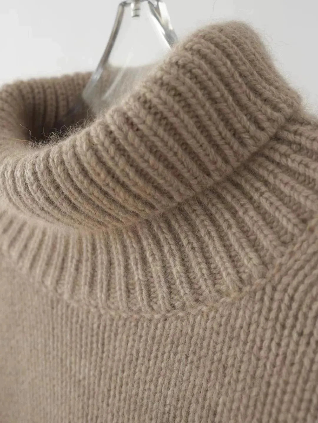Women's warm relaxed fit turtleneck sweater. Oversized, long sleeve, and comfortable for elegant winter fashion.
