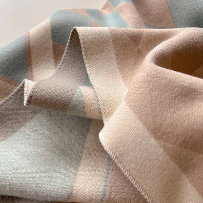 Beautifully folded cashmere women's shawl, ready to be worn as a warm, elegant winter accessory.