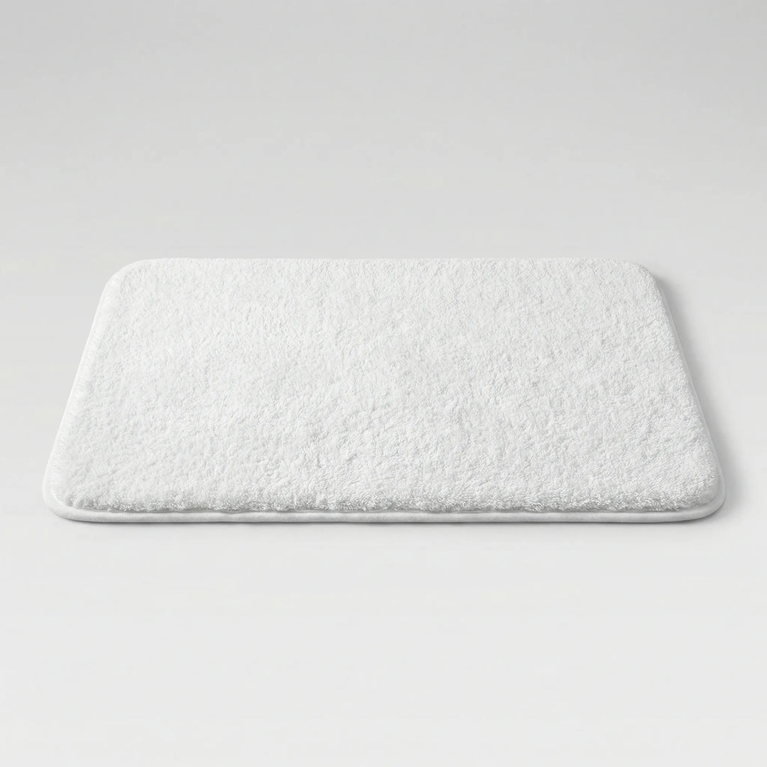 Soft, non-slip Flowique bath mat featuring a stylish wave pattern. Ideal for luxurious bathroom decor.