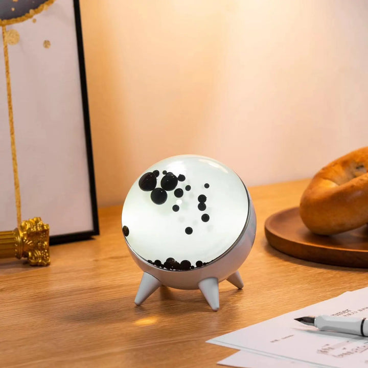 Dynamic ferrofluid liquid display reacting to music, doubles as a stylish tech gadget.