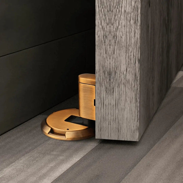 Self-adhesive magnetic door holder, no drilling required. Protects walls & doors, quick install for home safety.