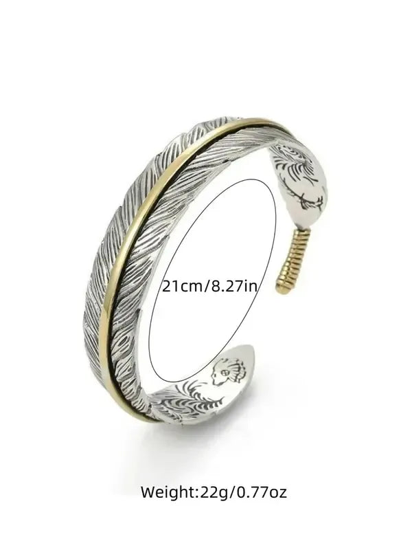 Men's adjustable stainless steel feather cuff bracelet worn on a wrist, displaying its sleek design and comfortable fit.