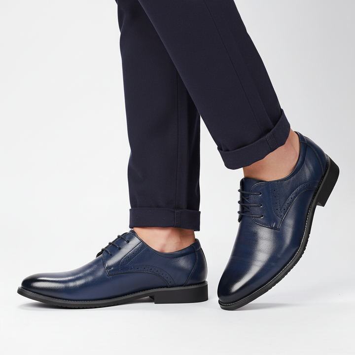 Side view of men's Adrian black leather dress shoes, showcasing classic brogue detailing and ergonomic design.