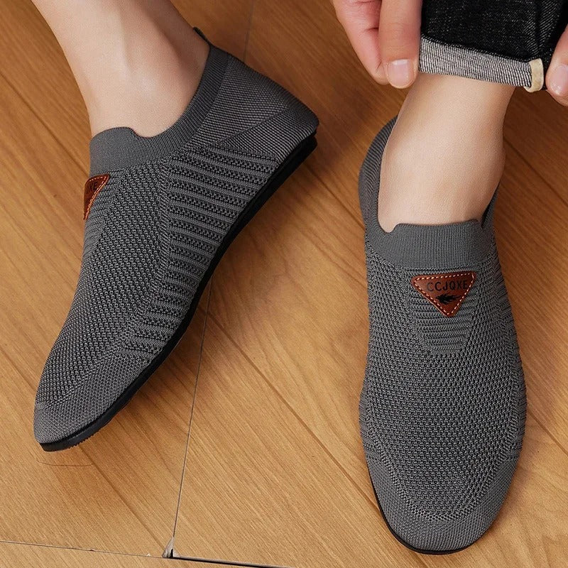 Side view of men's AirKnit breathable slip-on comfort shoes. Lightweight casual walking sneakers.