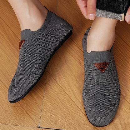 Side view of men's AirKnit breathable slip-on comfort shoes. Lightweight casual walking sneakers.