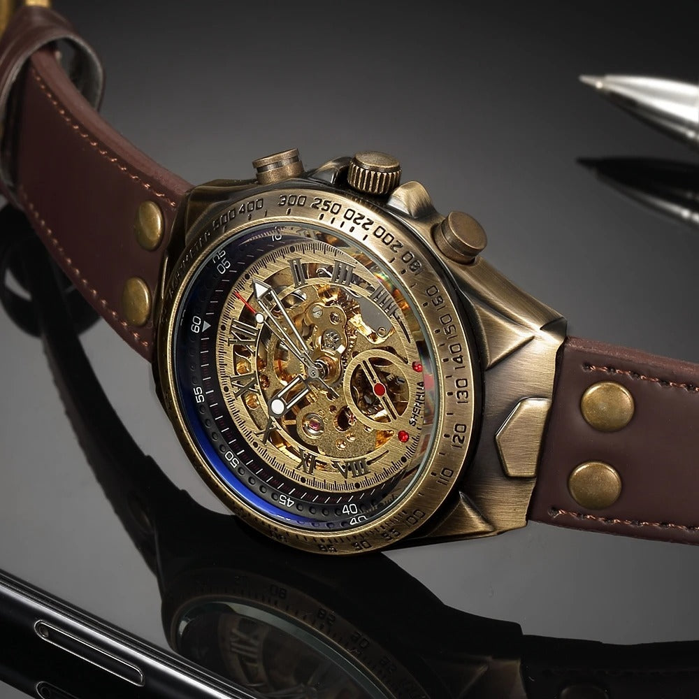 Close-up: Men's hand-wound mechanical skeleton watch, showcasing intricate gears, antique gold finish, leather strap.
