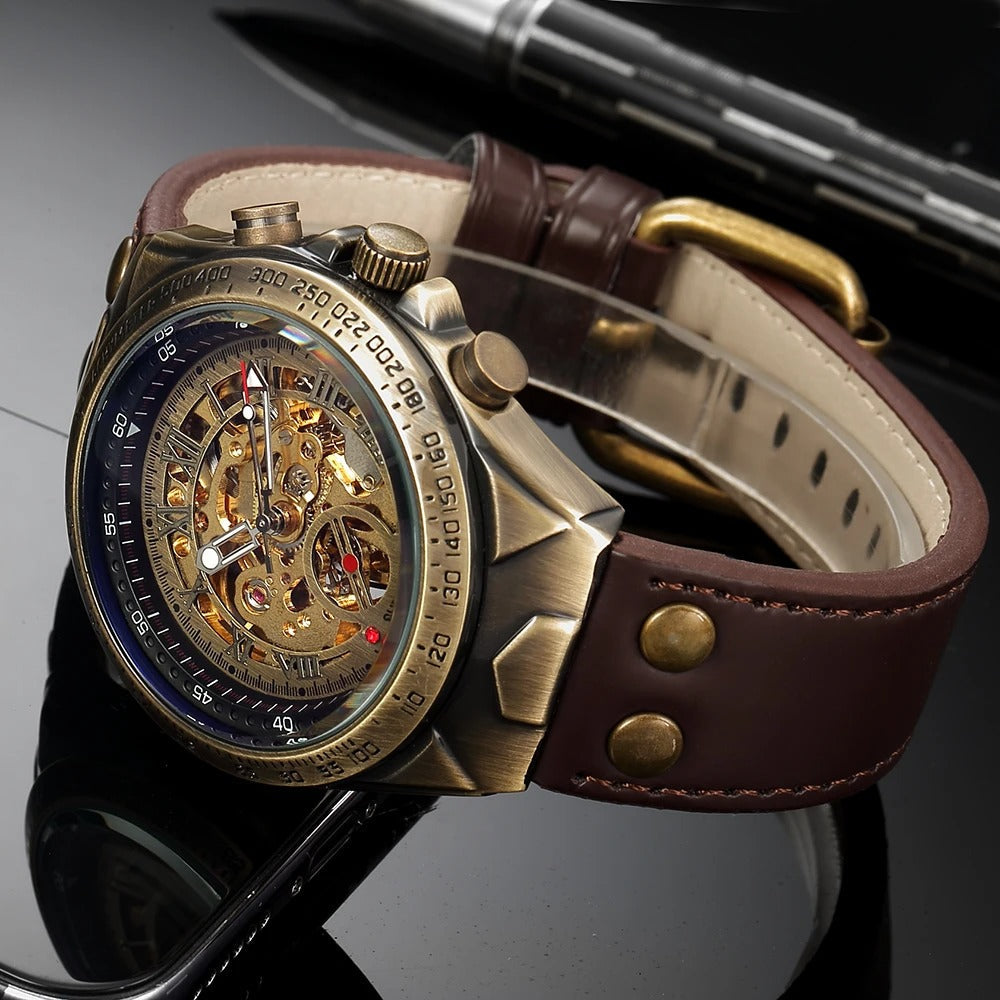 Vintage style men's skeleton watch with an open heart dial, antique gold case, and classic brown leather band.