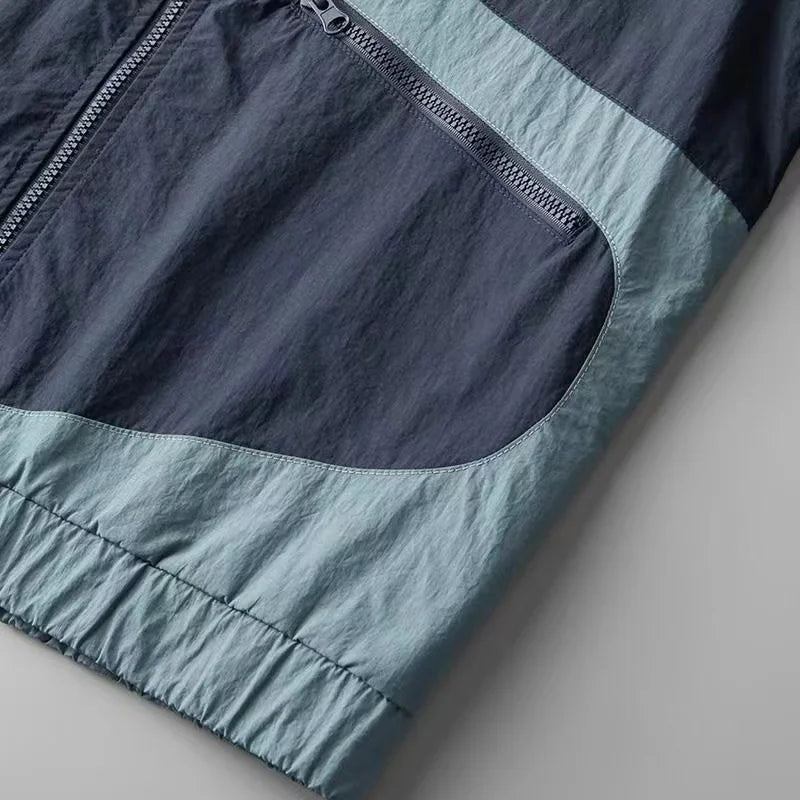 Stylish men's Apex colorblock windbreaker jacket. Lightweight casual outerwear for urban and outdoor activities.