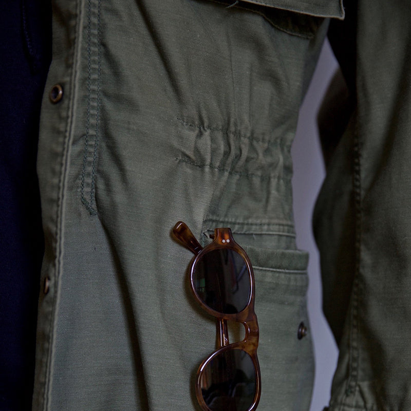 Rugged men's green hooded field jacket, perfect utility jacket for outdoor adventures. Versatile men's outerwear.