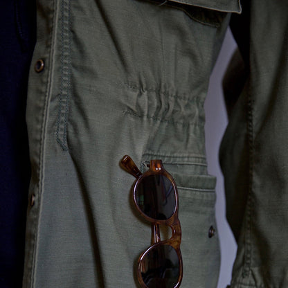Rugged men's green hooded field jacket, perfect utility jacket for outdoor adventures. Versatile men's outerwear.