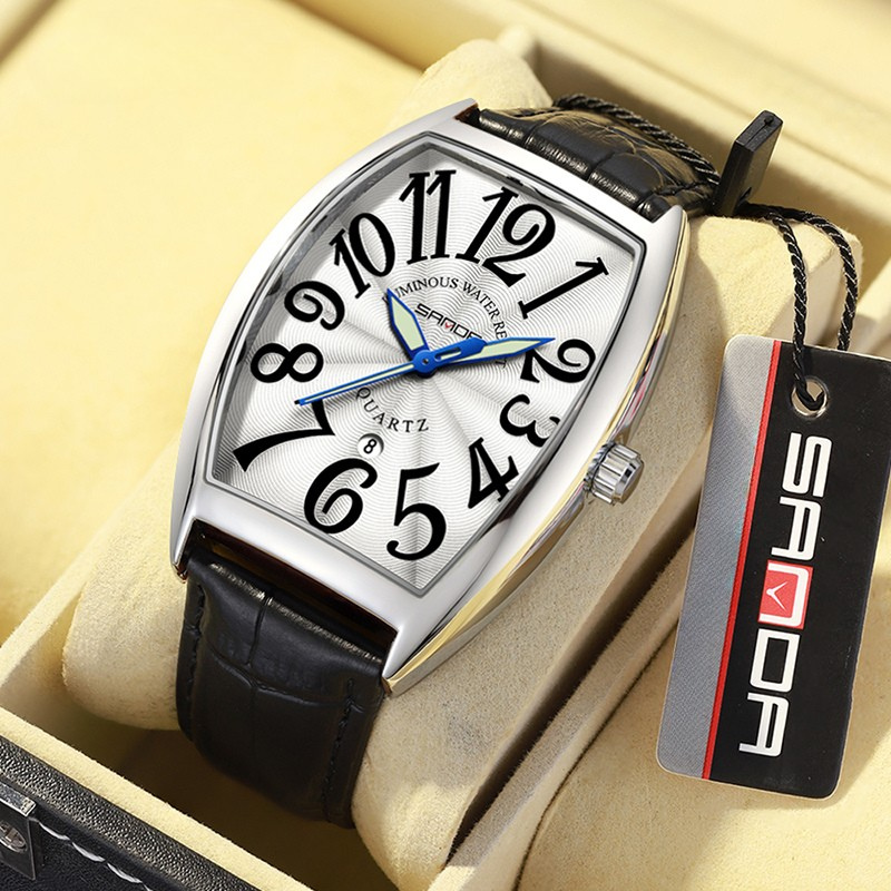 Side view of men's Art Deco tonneau watch, showing craftsmanship and leather strap.