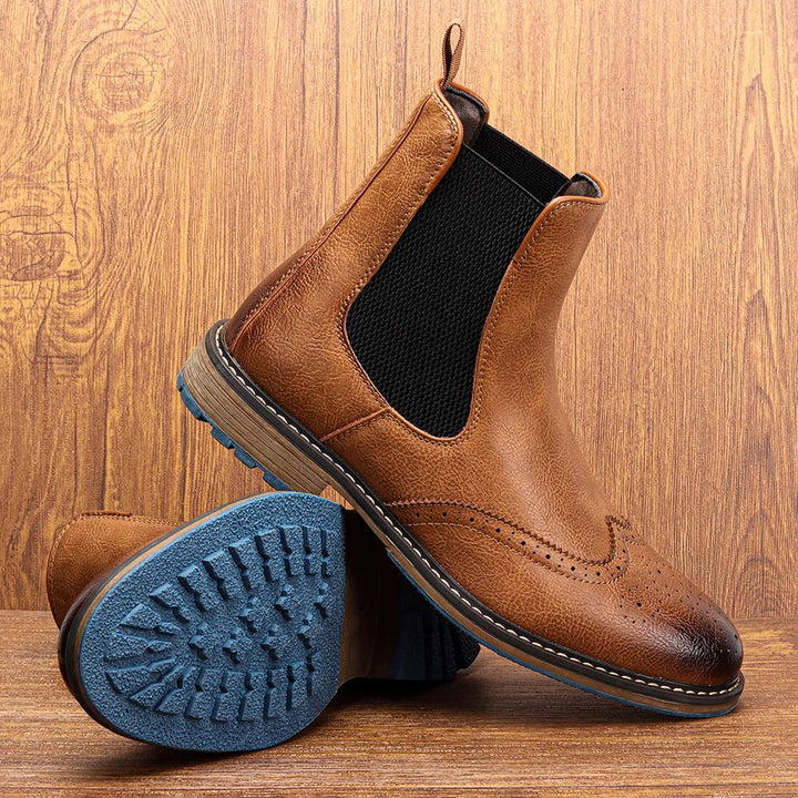 Stylish men's Arthur Chelsea boots featuring a unique blue sole, ideal for modern winter fashion and comfortable wear.