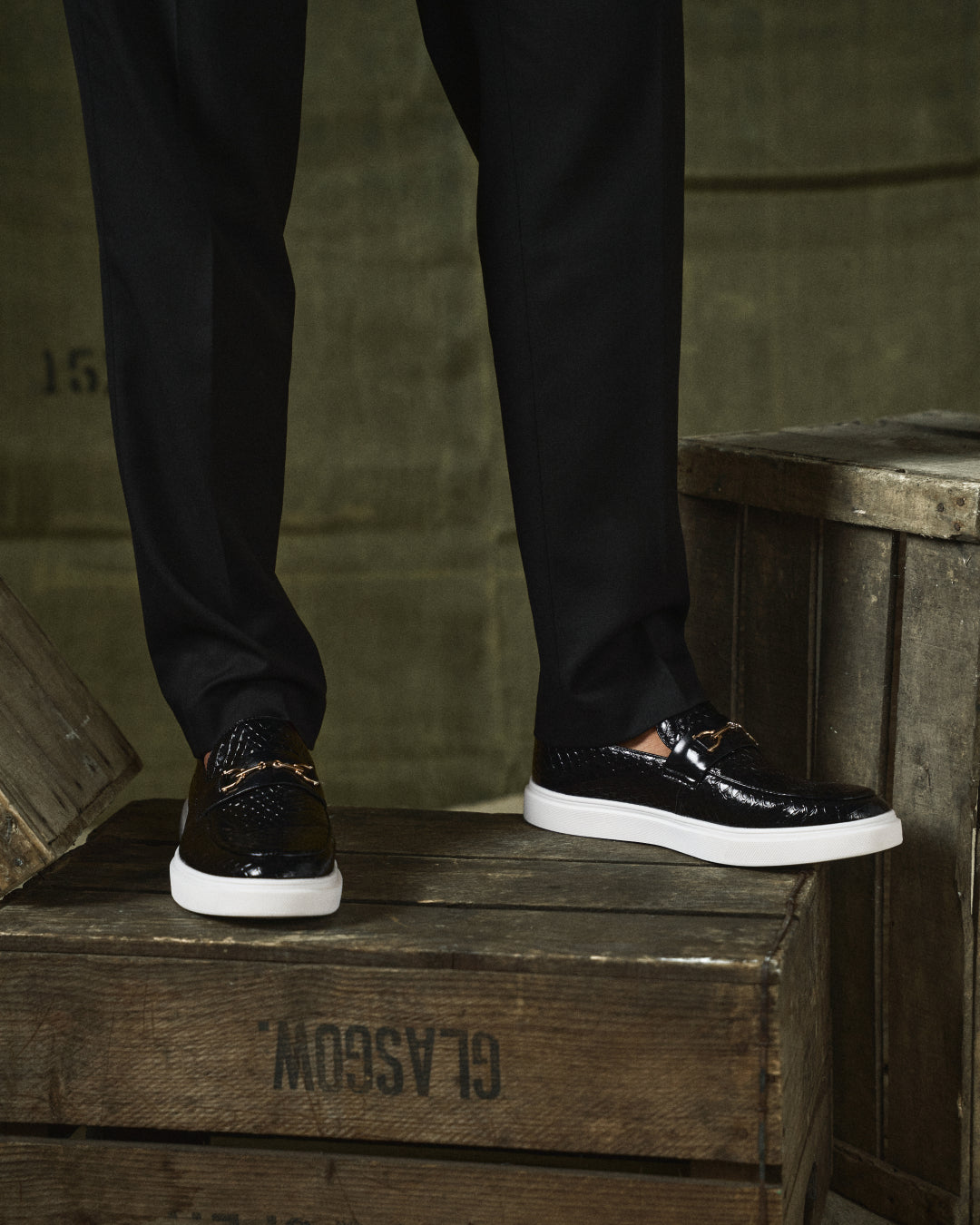 Front view of men's stylish Aureo loafers, showcasing the prominent gold-tone accent & slip-on design.