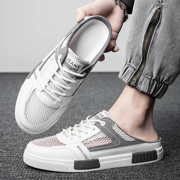 Clean white men's comfort slides, combining sneaker style with easy backless slip-on convenience.