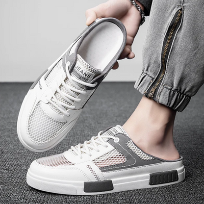 Clean white men's comfort slides, combining sneaker style with easy backless slip-on convenience.