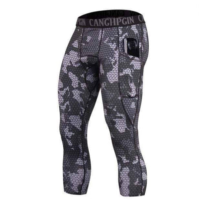 Men's activewear capri tights, black compression, engineered for running and athletic performance.