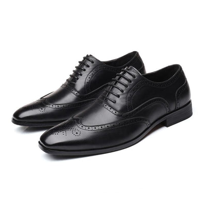 Detailed view of perforations on men's Oxford brogue dress shoes, highlighting craftsmanship.