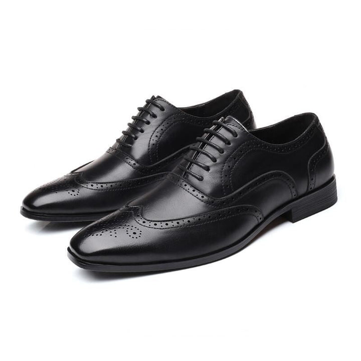 Detailed view of perforations on men's Oxford brogue dress shoes, highlighting craftsmanship.