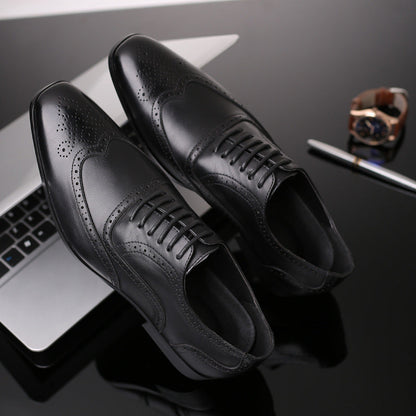 Men's Oxford brogue dress shoes paired with a suit, ideal for formal business attire.