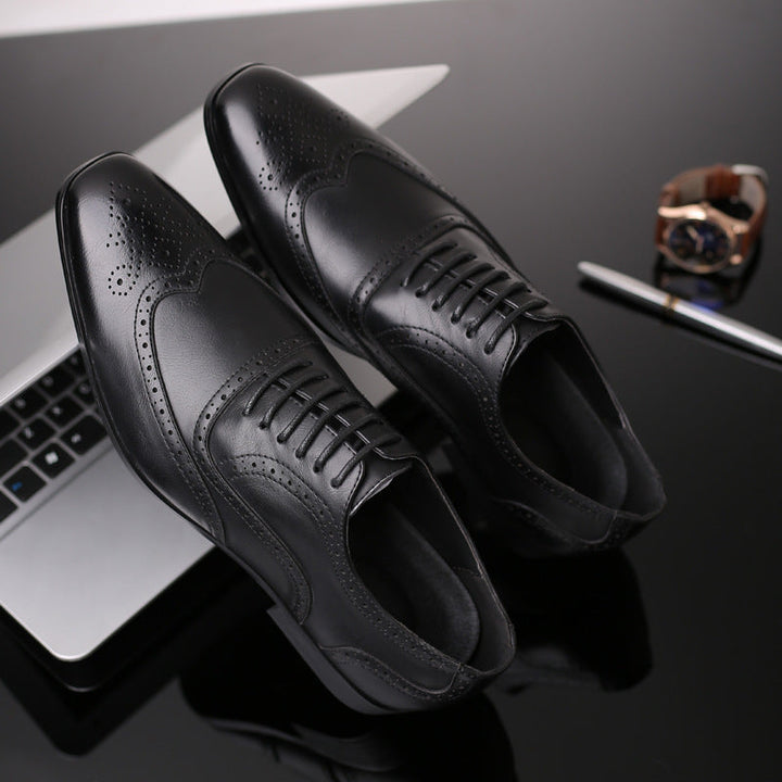 Men's Oxford brogue dress shoes paired with a suit, ideal for formal business attire.
