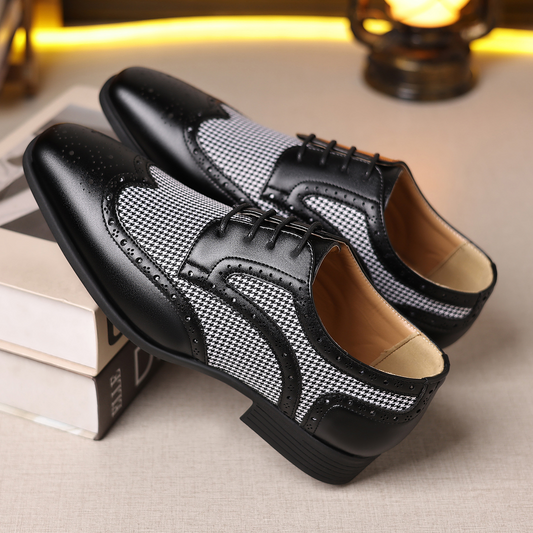 Men's black leather wingtip dress shoes with classic brogue details, perfect for formal business attire.