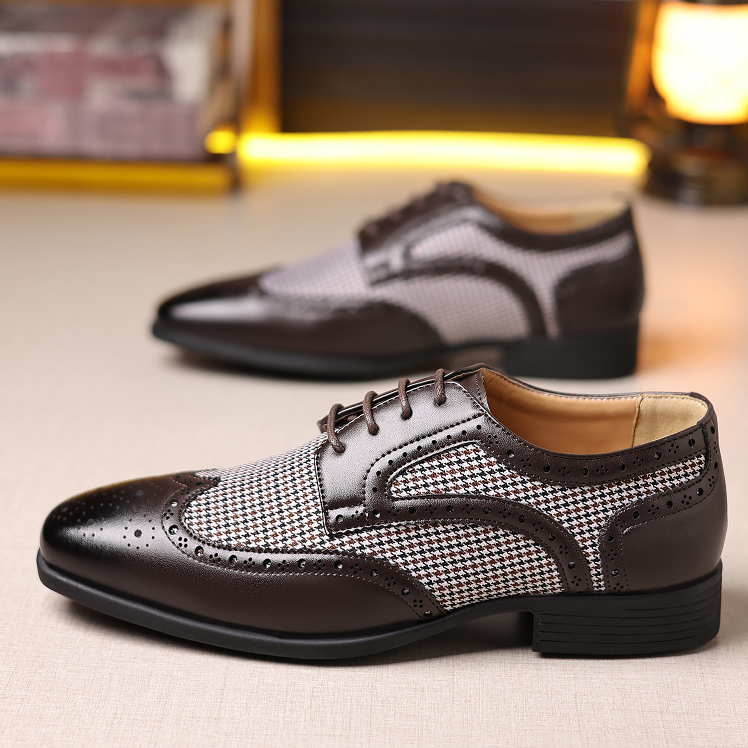 Formal men's wingtip dress shoes in dark brown, featuring detailed broguing for a distinguished look.