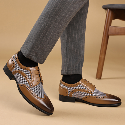 Classic men's wingtip leather shoes with fine broguing, combining comfort and formal elegance.